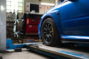 blue car in auto repair shop