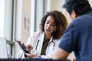 female doctor showing images to patient