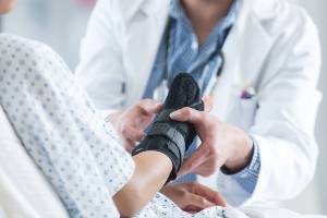 doctor examining wrist brace