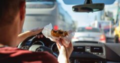 eating a cheeseburger behind the wheel