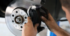 mechanic repairing car brakes