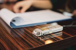 dictaphone on desk with notepad