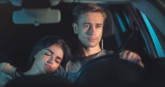 tired couple in car at night