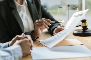 Lawyer in law firm showing paperwork.